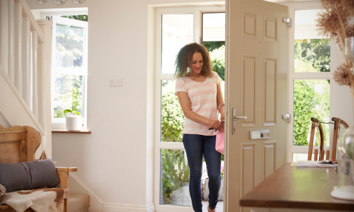 Woman walking through door